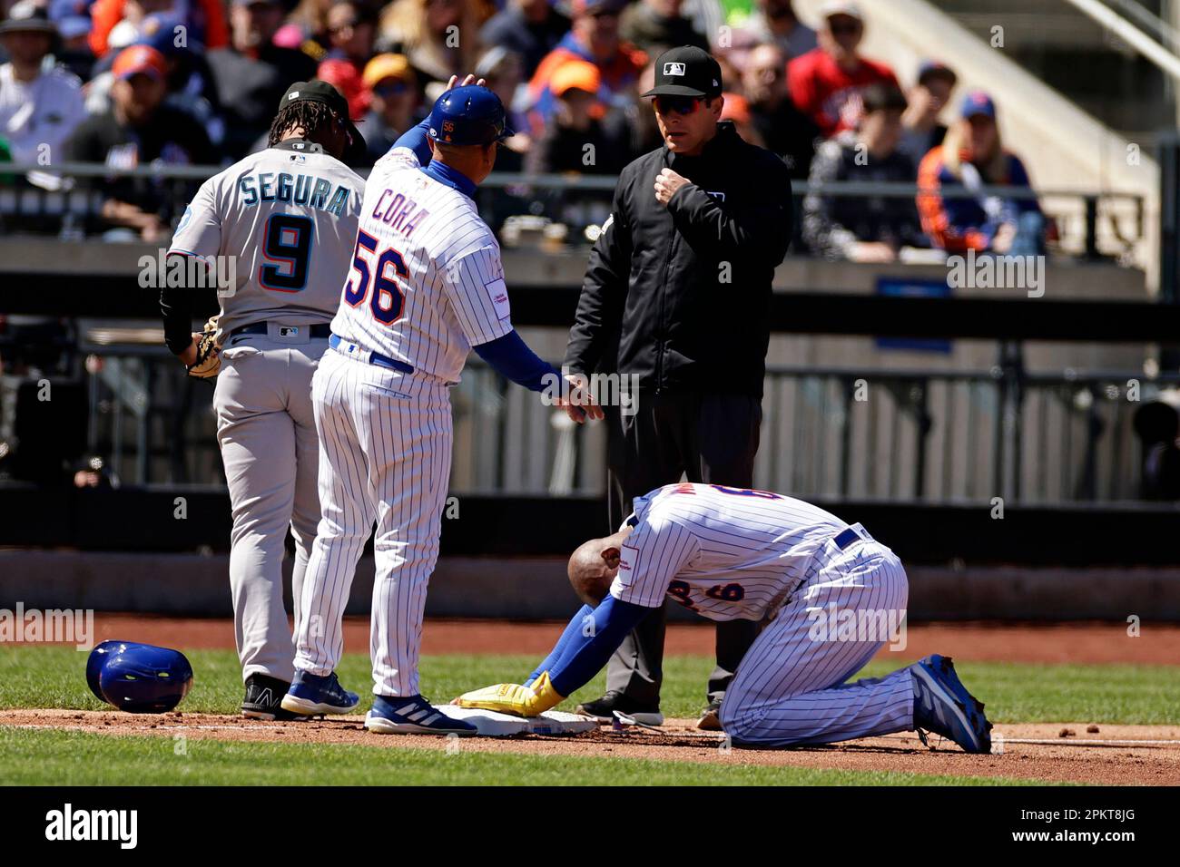 New York Mets infield & third base coach Joey Cora (56) asks for time after  Starling Marte collided with Miami Marlins third baseman Jean Segura (9)  during the first inning of a