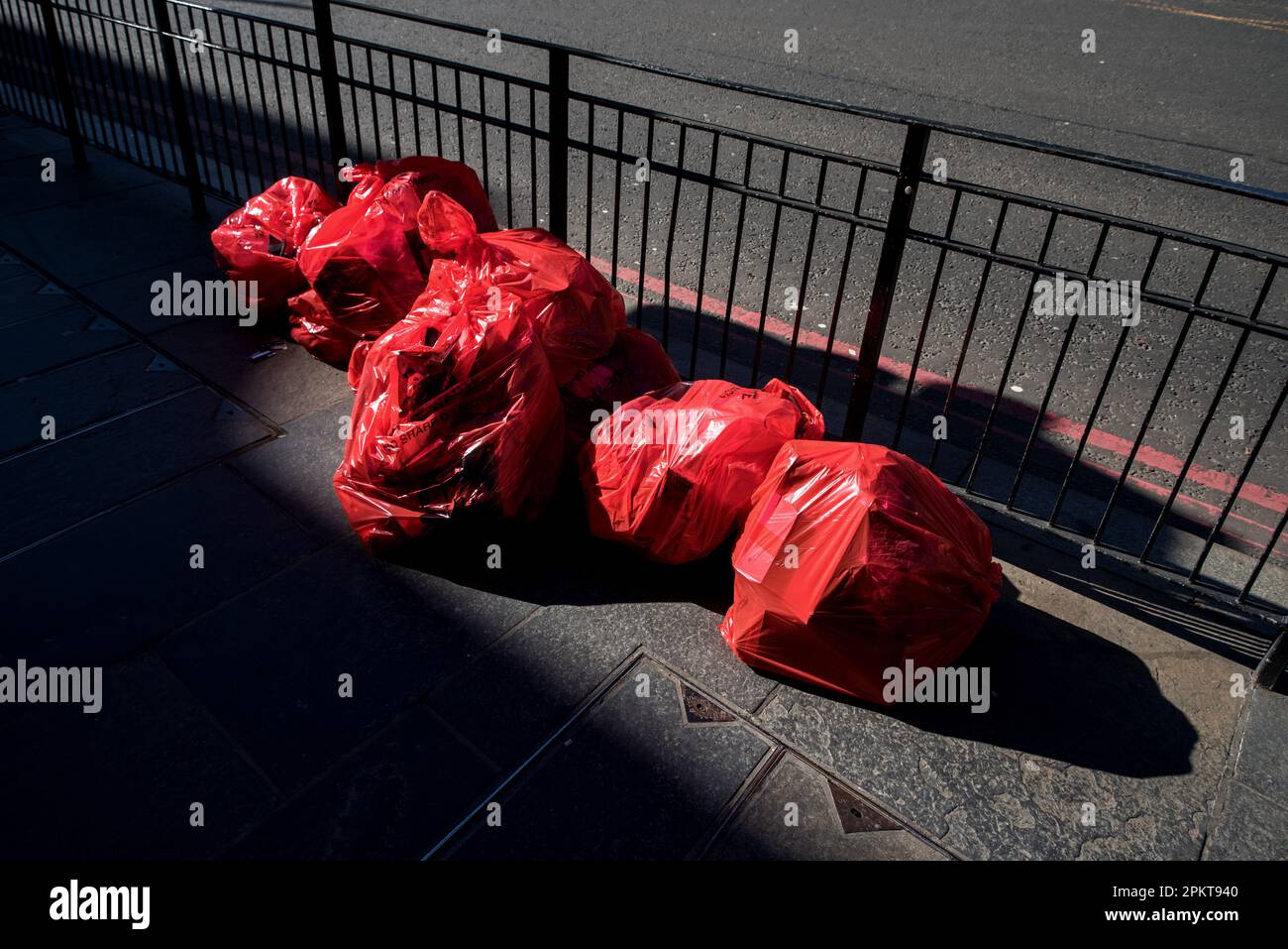 Red plastic waste sacks filled and awaiting collection in Edinburgh