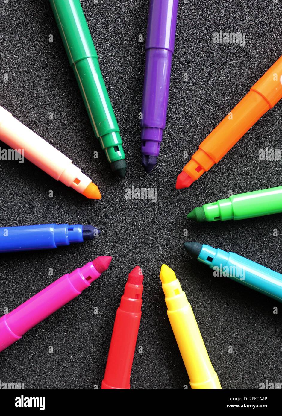 https://c8.alamy.com/comp/2PKTAAP/open-felt-tip-pens-of-different-colors-in-the-shape-of-a-star-lie-on-a-black-background-vertical-photo-2PKTAAP.jpg