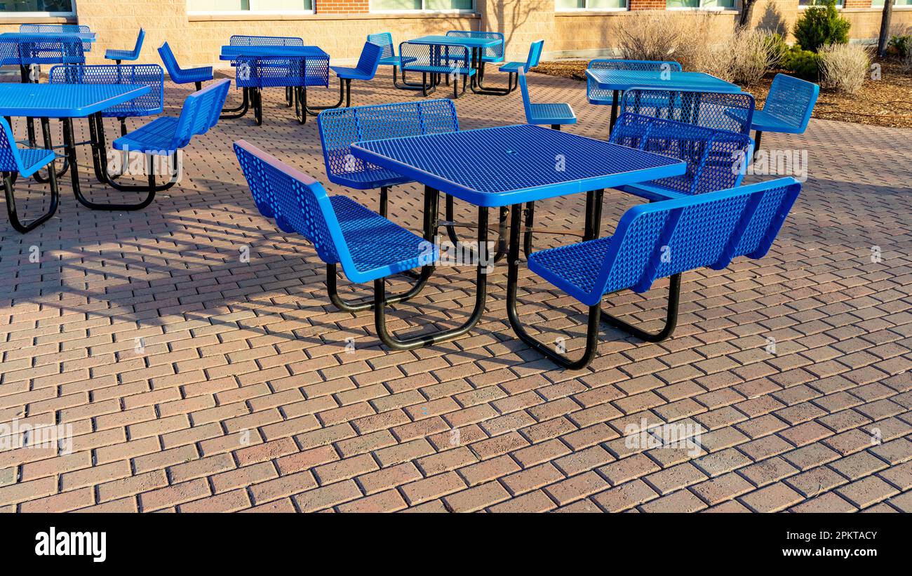 Blue tables on a brick patio for executives Stock Photo Alamy