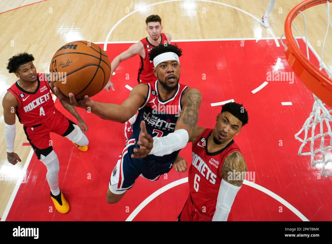 Washington Wizards guard Jordan Goodwin center goes up against
