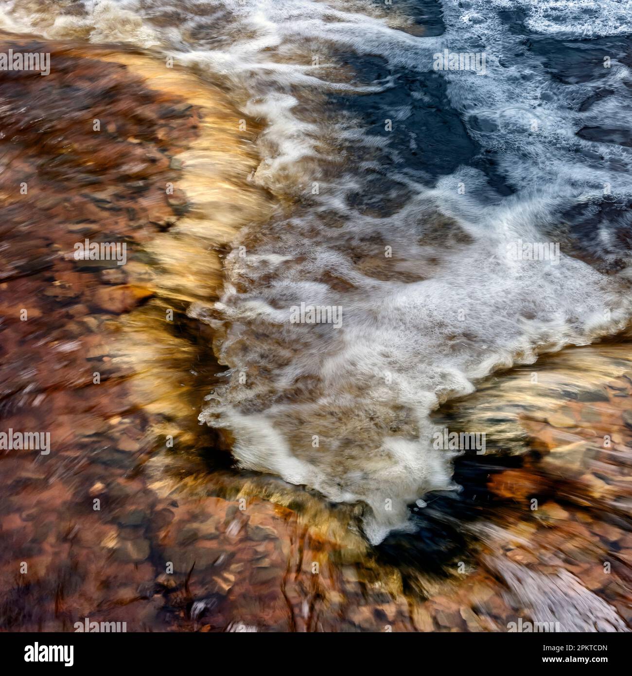 The quick flowing water of the Grootrivier River flow over rocks after heavy rains in the Tsitsikamma Mountains of the southern coastline of South Afr Stock Photo