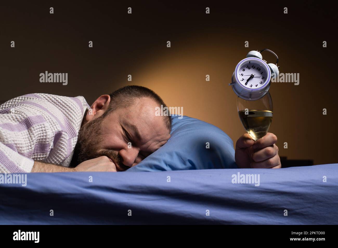 Man and alcoholism. Get drunk with alcohol and oversleep the alarm clock concept. Hangover agony