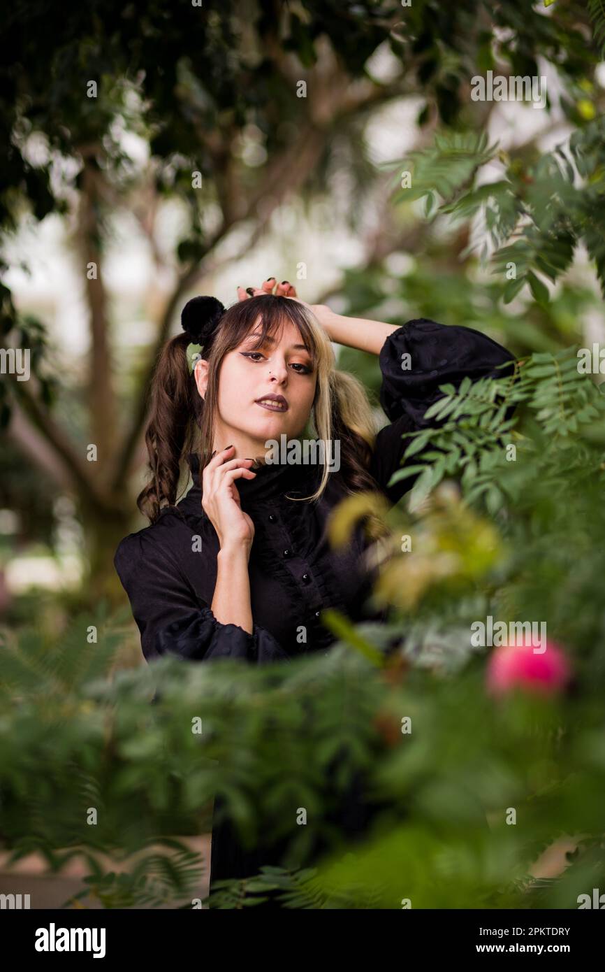 gothic lolita victorian cosplay costume. Hispanic young woman cheerful portrait outdoor background Stock Photo