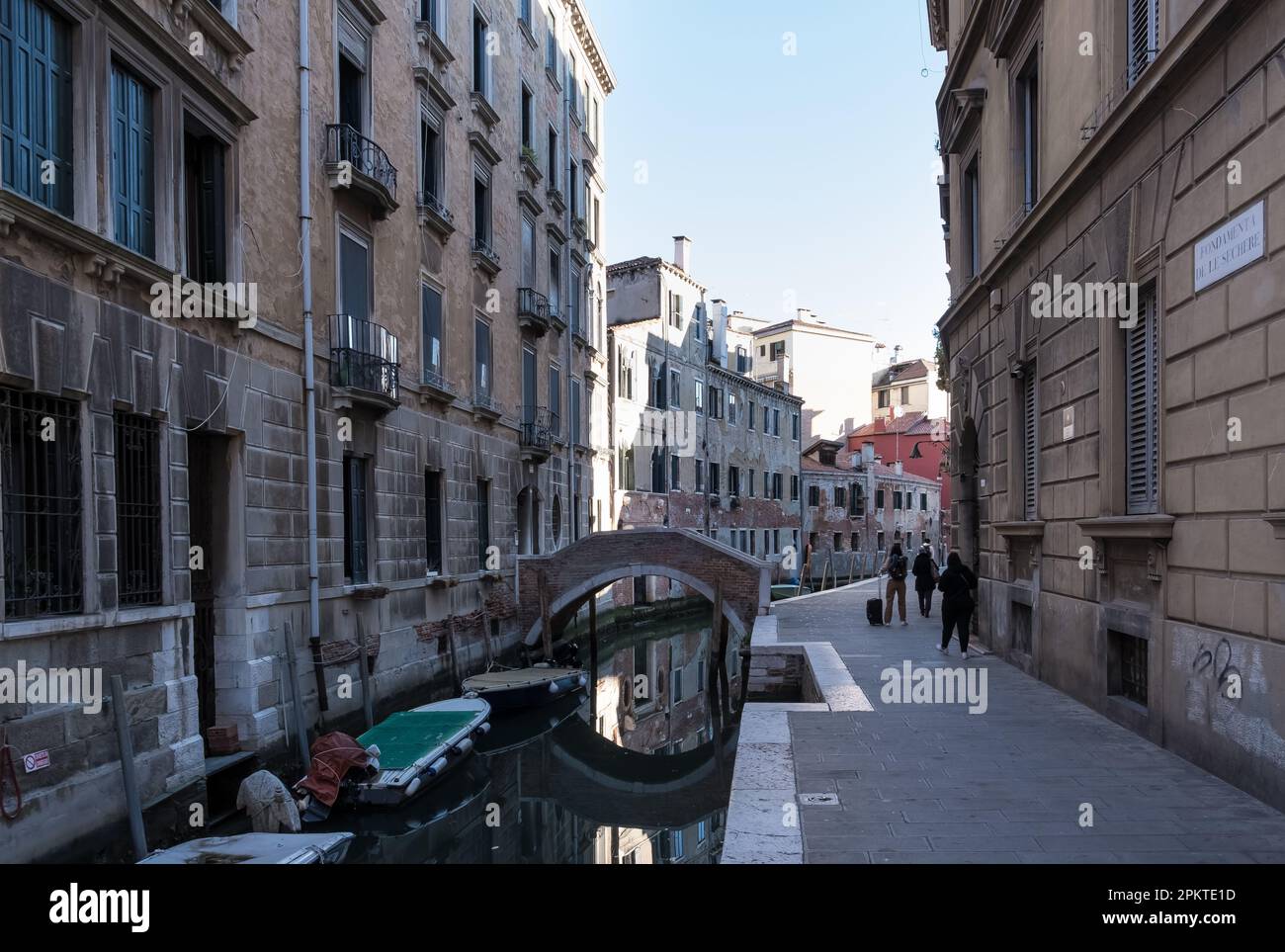 View of Fondamenta de le Sechere, a street showcasing intricate, time-honored features along the  picturesque Venetian canal-side promenade Stock Photo