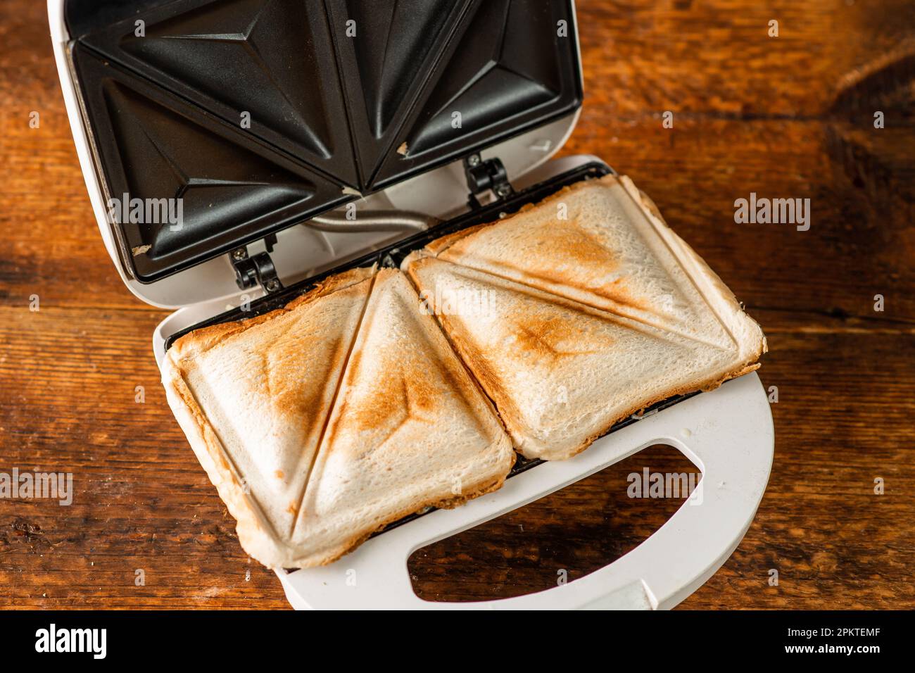 Making toasted sandwiches with a vintage French sandwich press