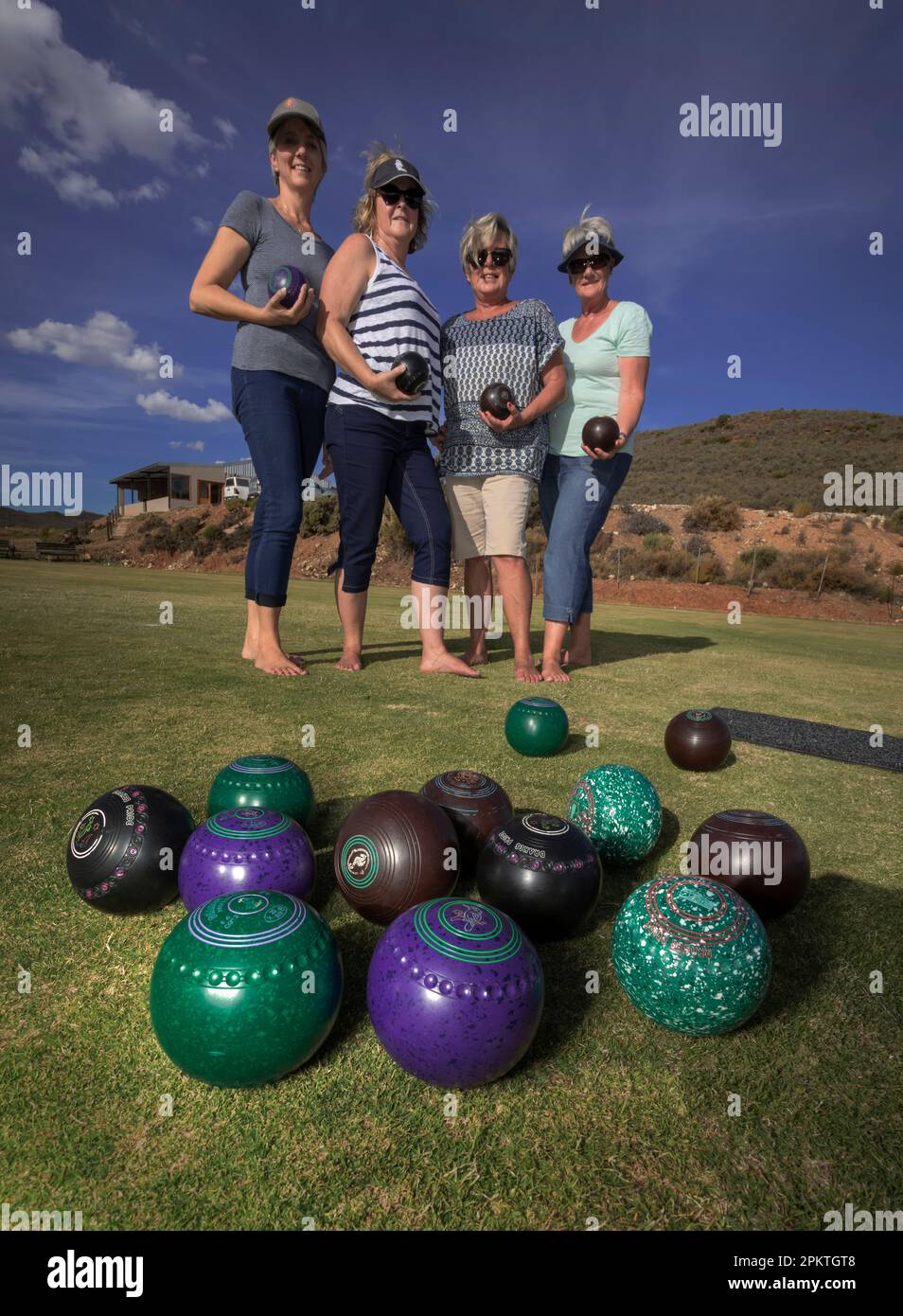 Four members of the Uniondale Bowling Club pose for the camera during a match. Stock Photo