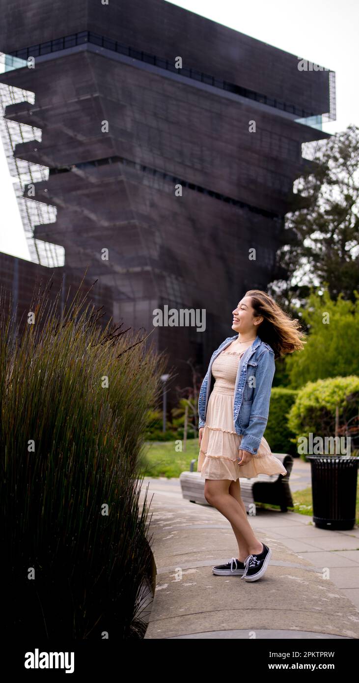 Asian Teen with Hair Blowing in the Wind Standing in Front of De Young ...