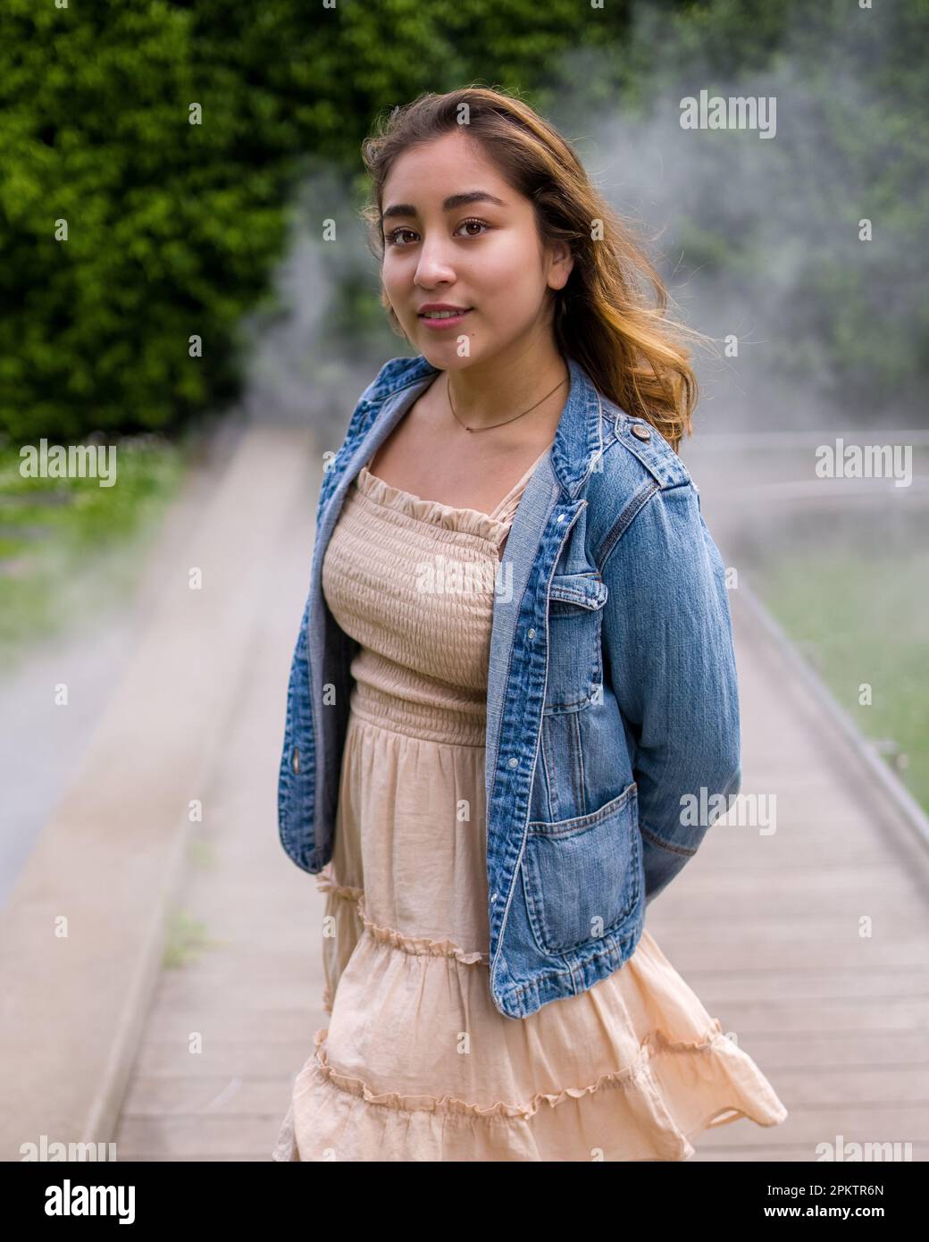 Asian Teen Walking on Misty Walkway | De Young Museum Gardens | Female | Short Dress Denim Jacket Stock Photo