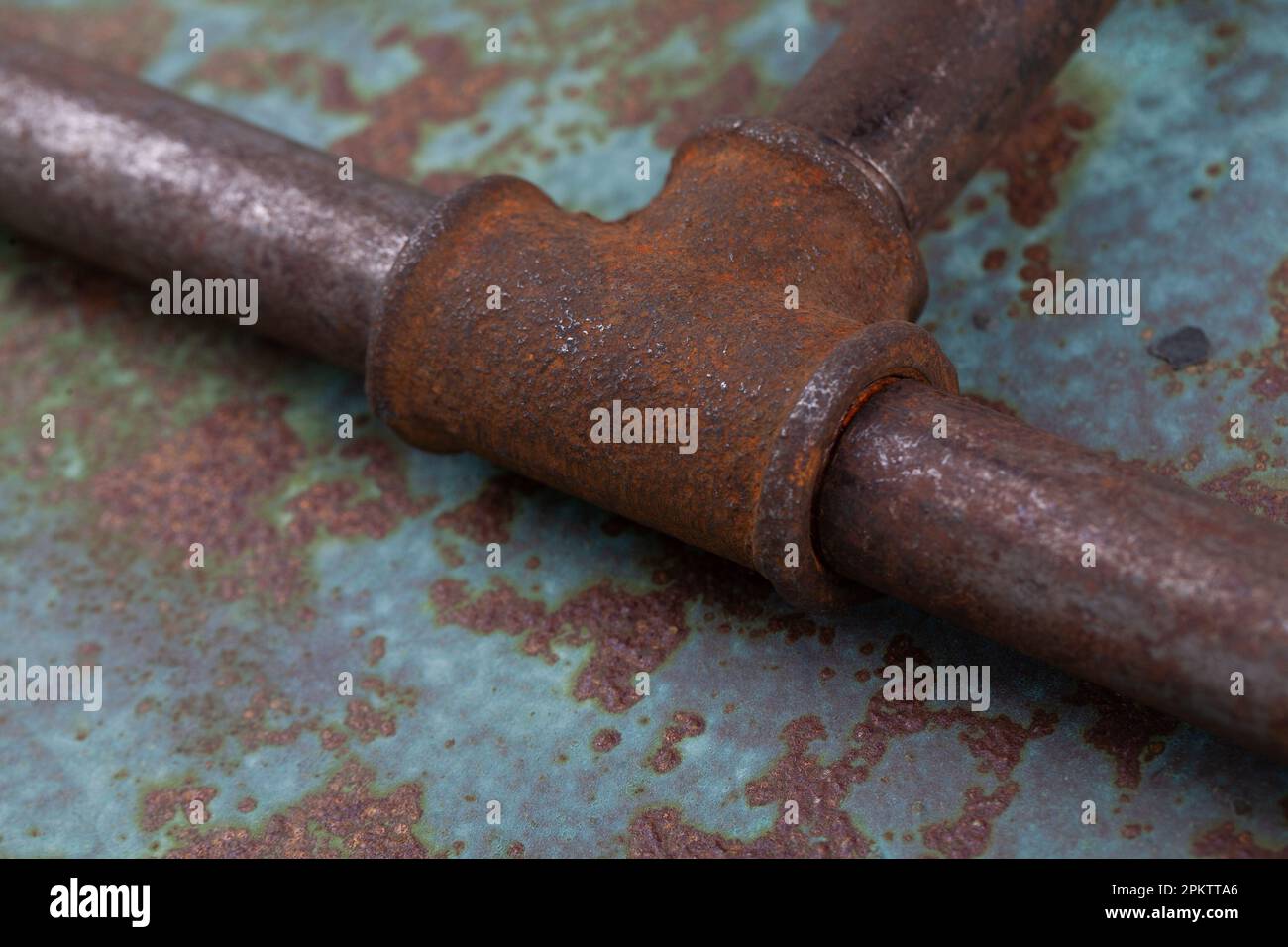 Rusty valve pipes on rusty metal wall background Stock Photo - Alamy