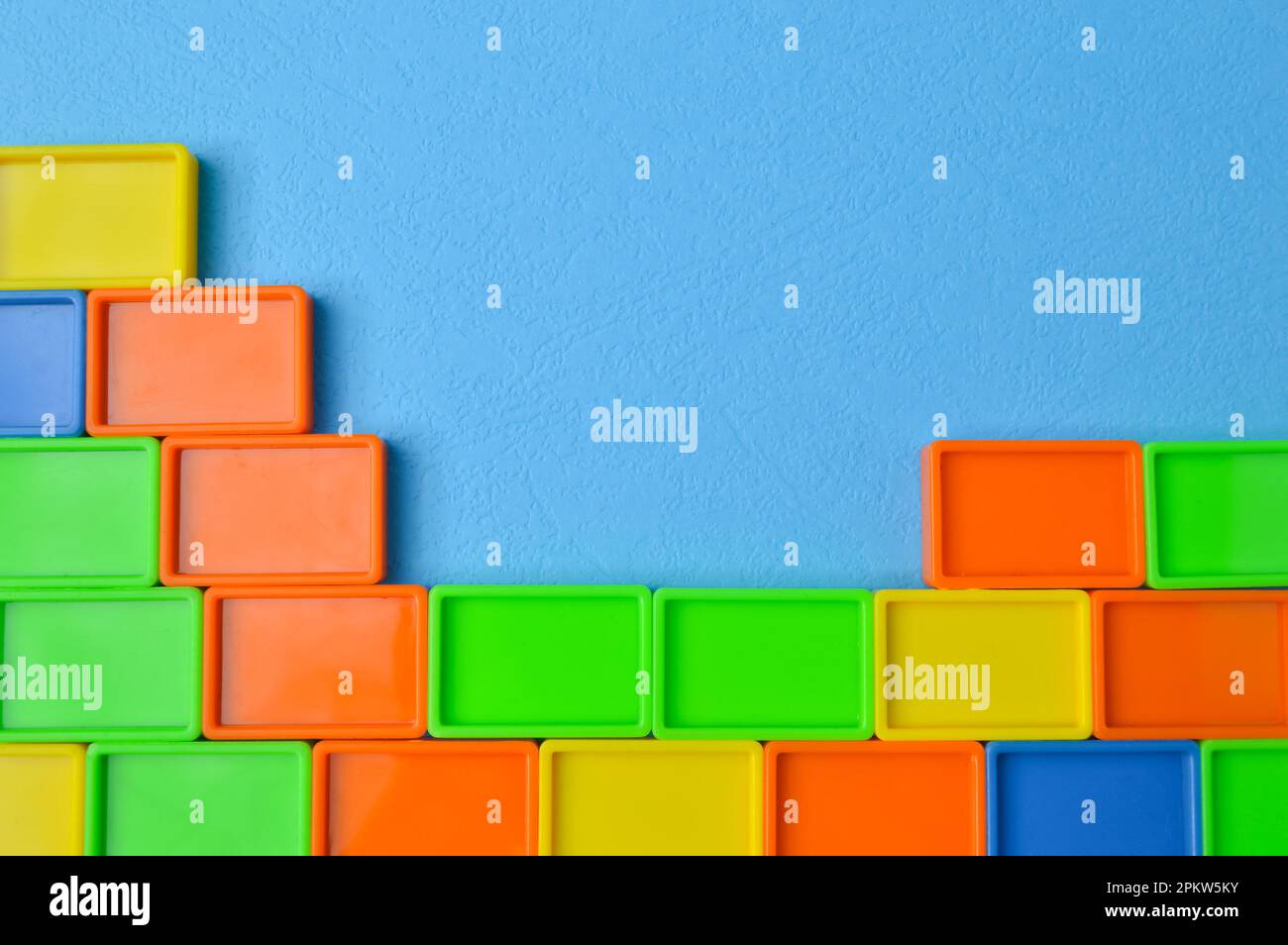Plastic toy building blocks isolated on a blue background Stock Photo ...