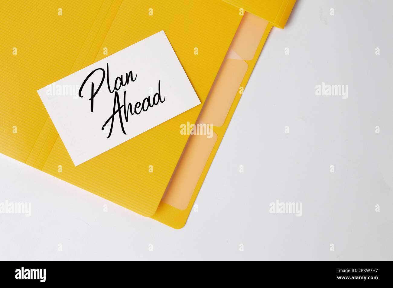 Memo note written with text PLAN AHEAD. Top view. Stock Photo