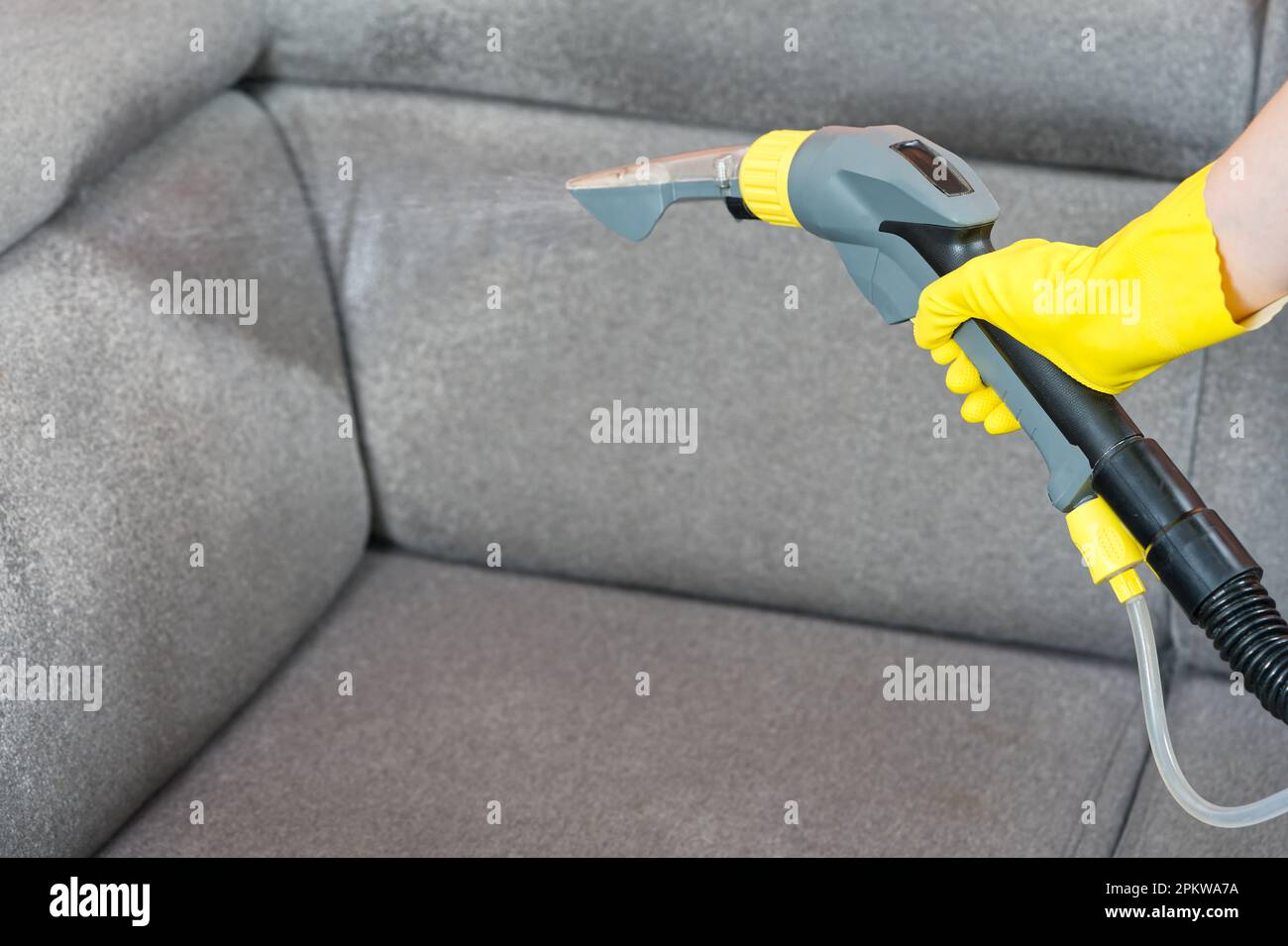 Textile sofa chemical cleaning with professionally extraction method. Upholstered furniture