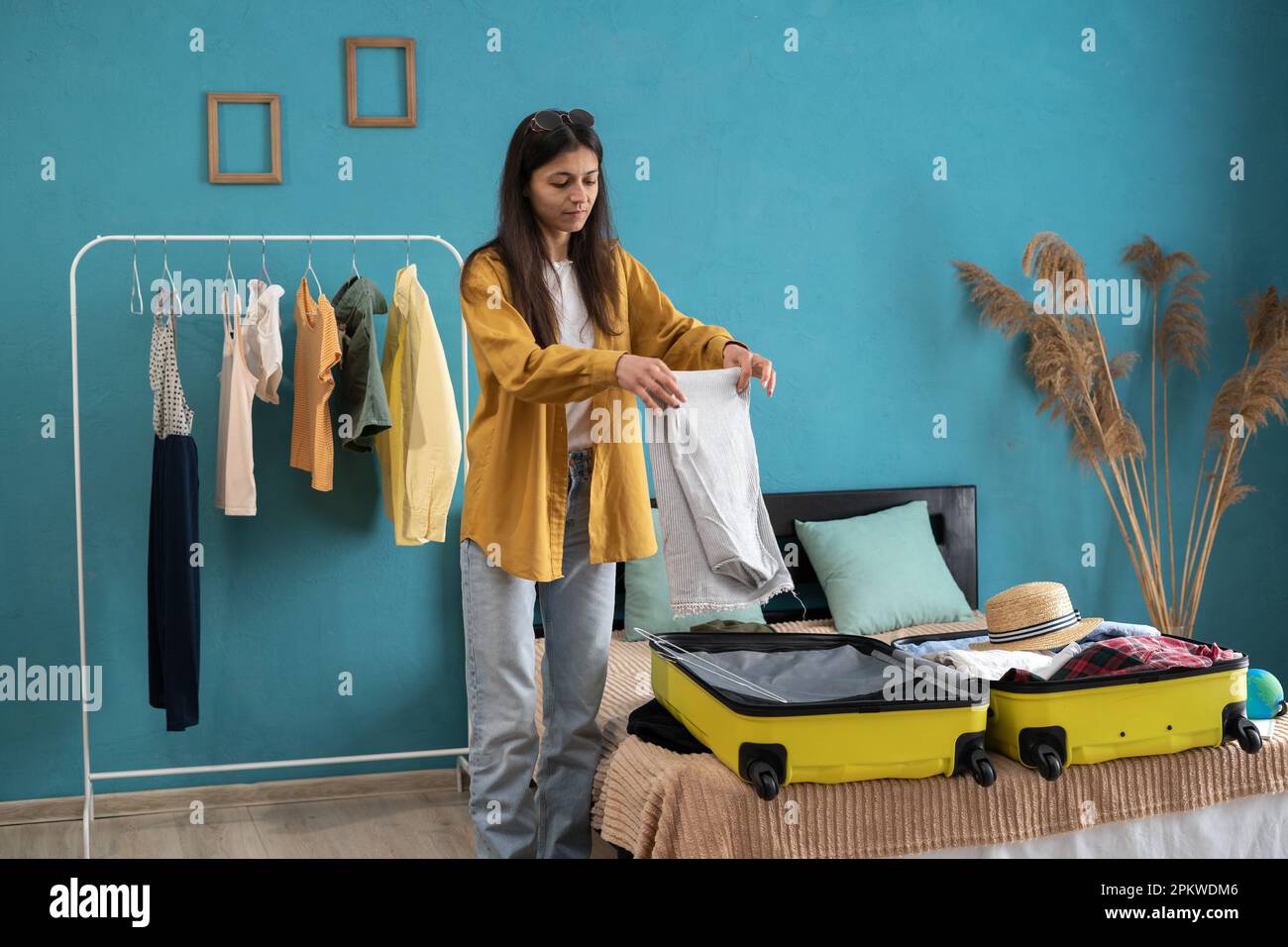 Young Woman Packing Clothes into Travel Bag Stock Image - Image of