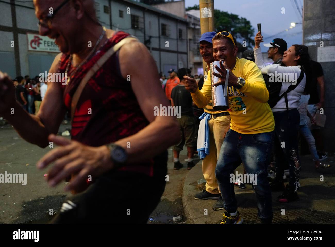 People dance and celebrate after an effigy representing Judas Iscariot ...