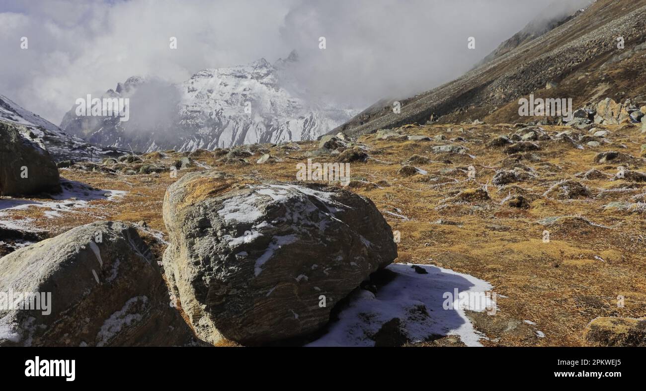 alpine tundra landscape and snowcapped himalaya mountains at zero point or yumesodong valley in north sikkim, india Stock Photo