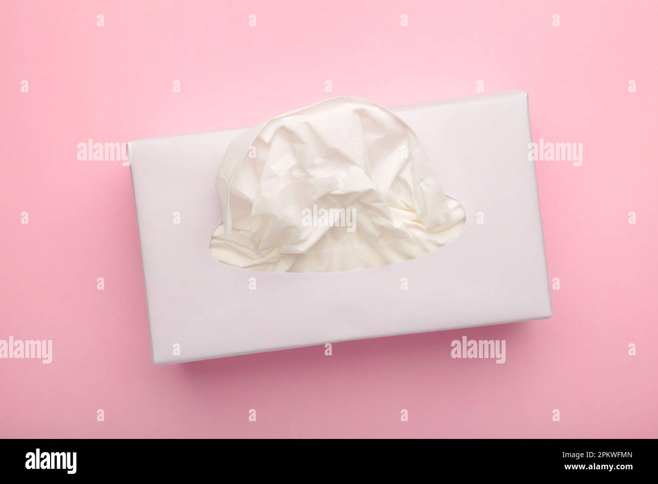 Box with paper tissues on pink pastel background.Top view Stock Photo