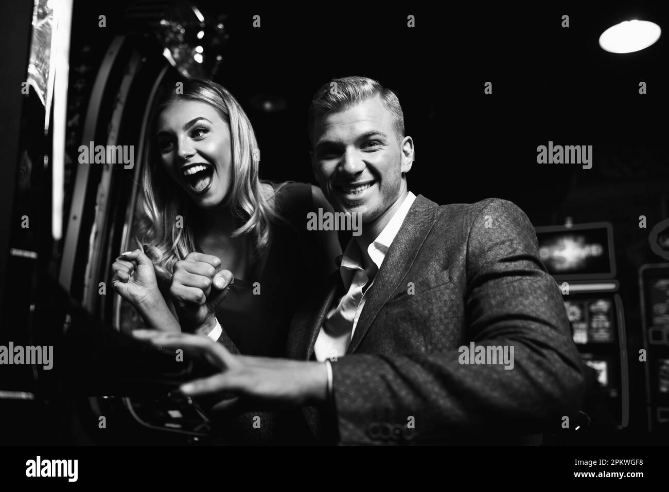 Young Group of People at the Automat Machine in a Casino and Celebrate Stock Photo