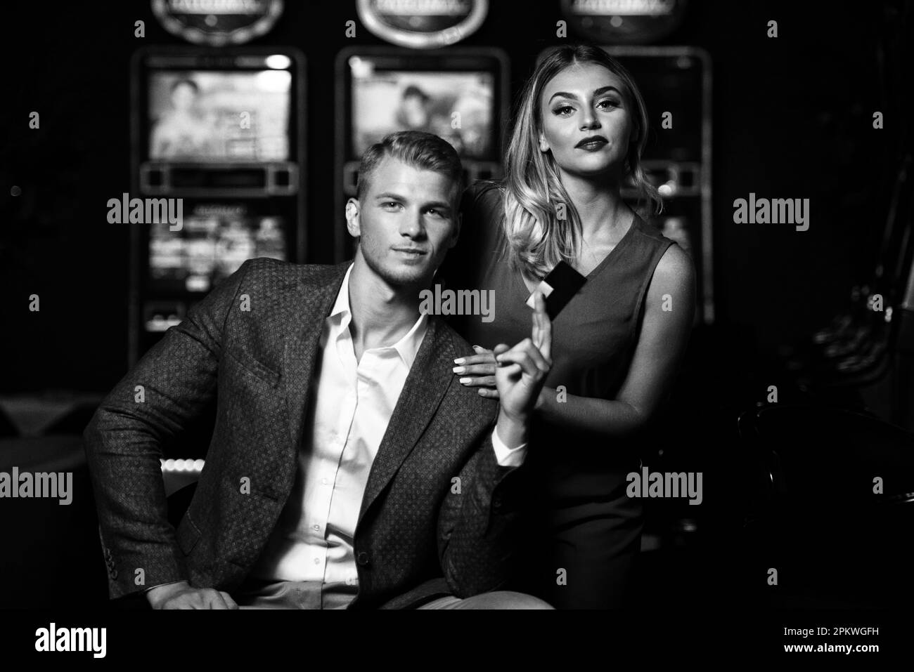 Portrait of a Young Beautiful and Well Dressed Couple Playing in the Casino and Celebrate Holding Vip Card Stock Photo