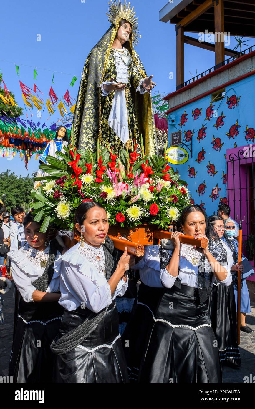 Mexican devotees carry the religious palanquin during during the Good Friday procession, on the Holy week, Oaxaca de Juárez , Mexico Stock Photo