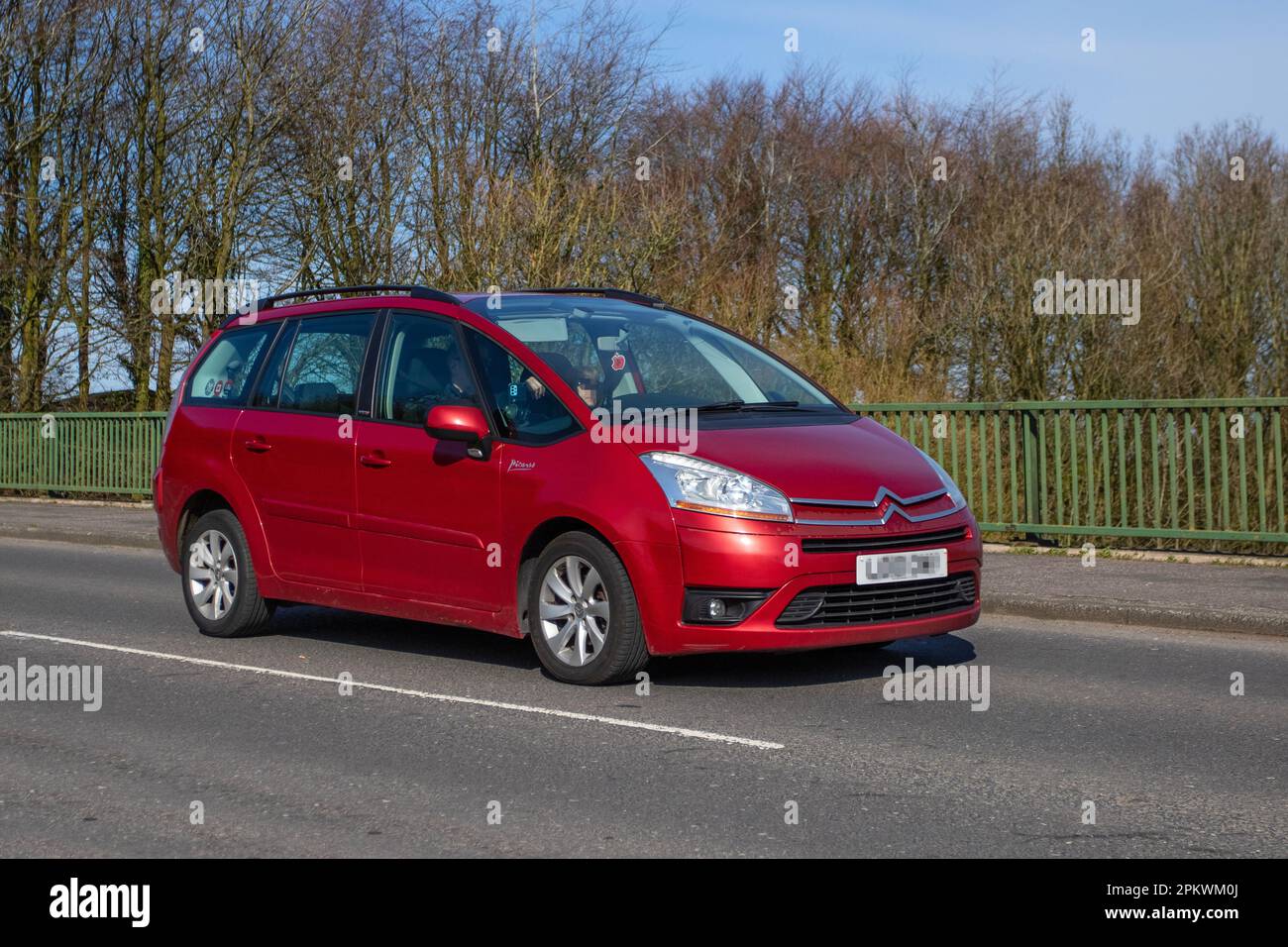 2010 Red CITROEN C4 Grand Picasso  Vtr+ Hdi; crossing motorway bridge in Greater Manchester, UK Stock Photo