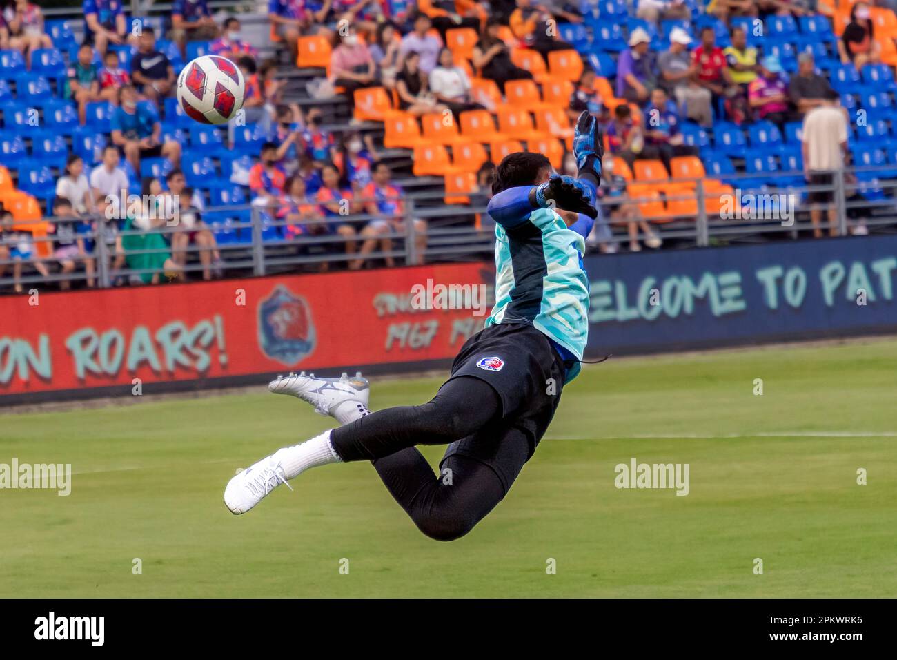 Thai goalkeeper practising saves during warm up for league game, PAT ...