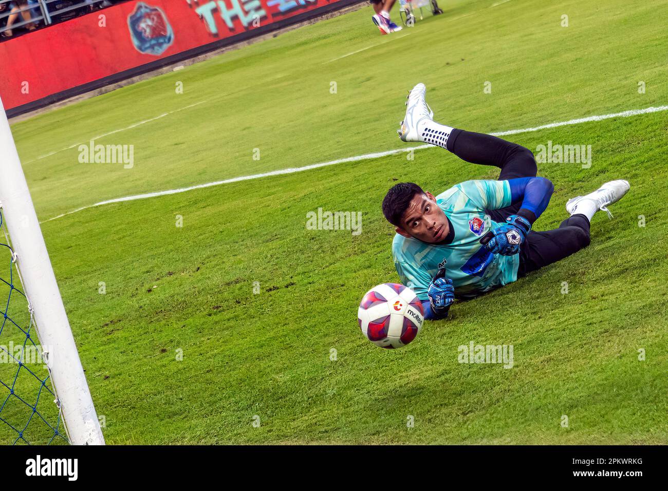 Thai goalkeeper practising saves during warm up for league game, PAT ...
