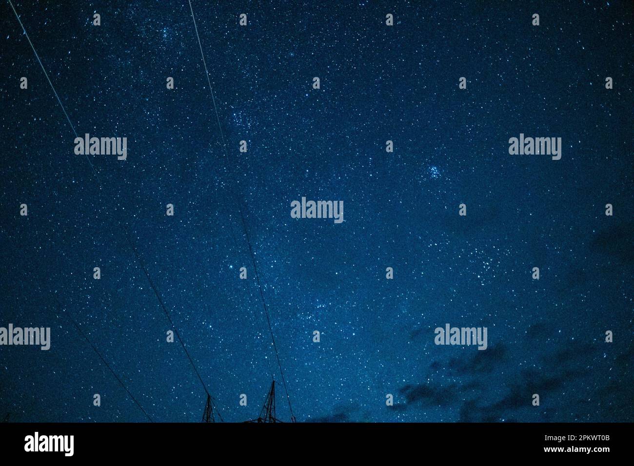 A low-angle shot of the telephone poles under a starry sky Stock Photo ...