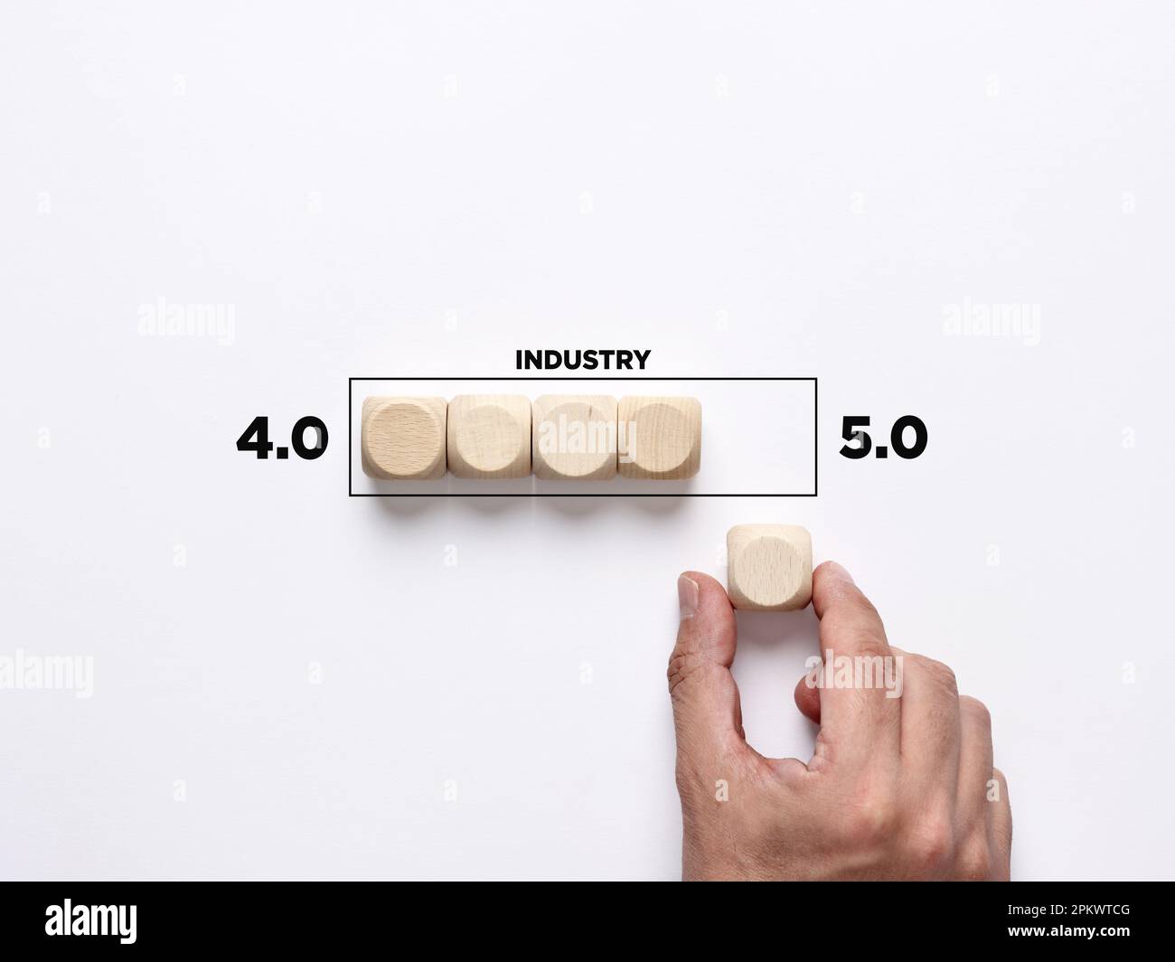 Technological change in business industry. Moving from industry 4.0 to 5.0. Hand places a wooden cube to the loading bar moving from industry 4.0 to 5 Stock Photo