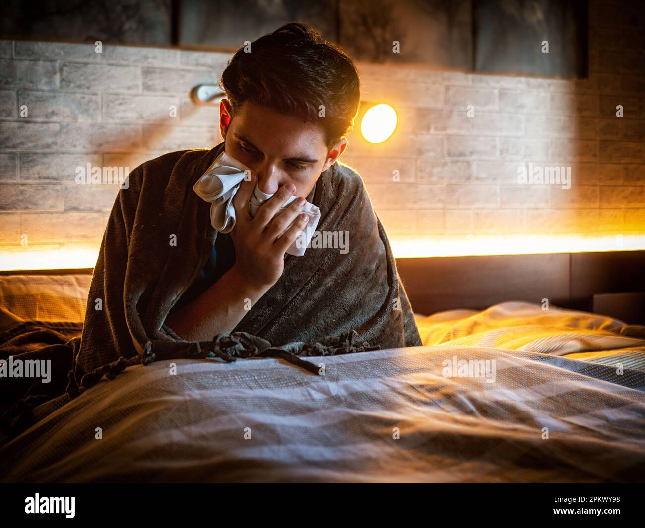 Young man blowing his nose with handkerchief Stock Photo Alamy