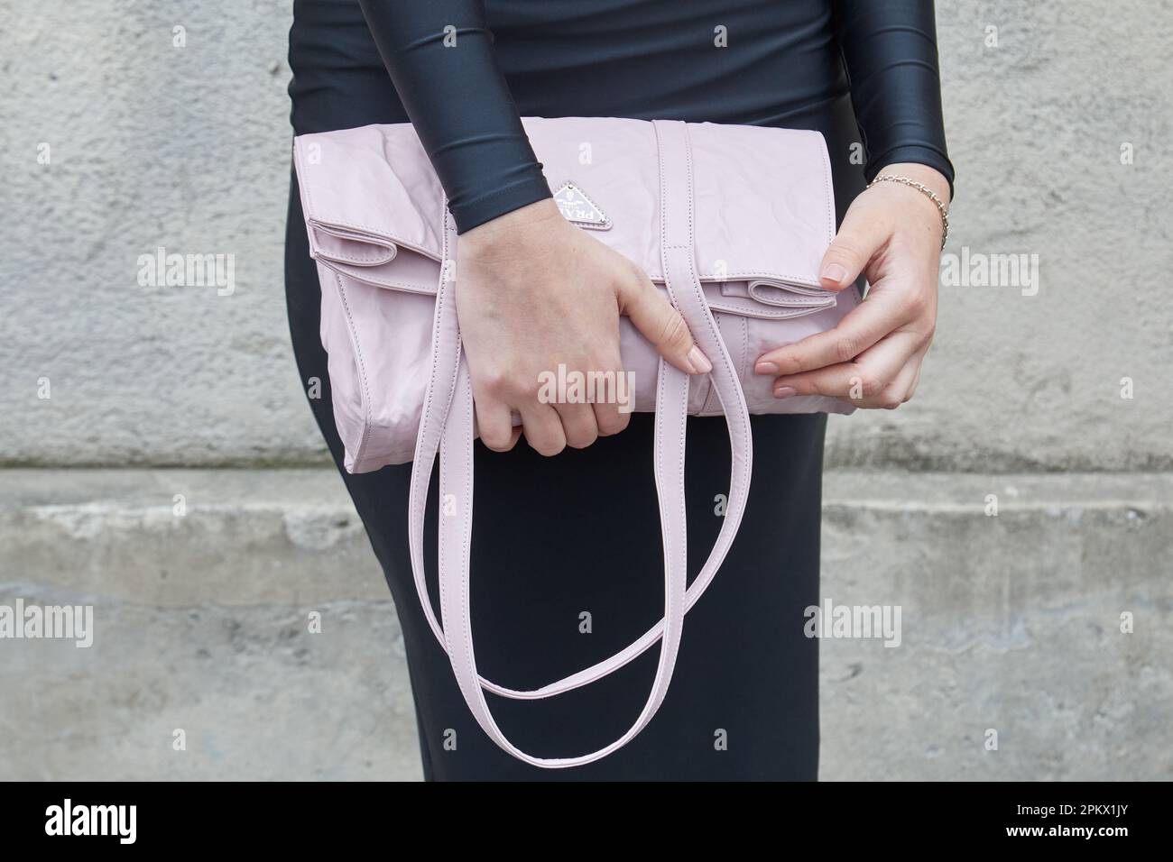 MILAN, ITALY - FEBRUARY 23, 2023: Woman with light pink Prada