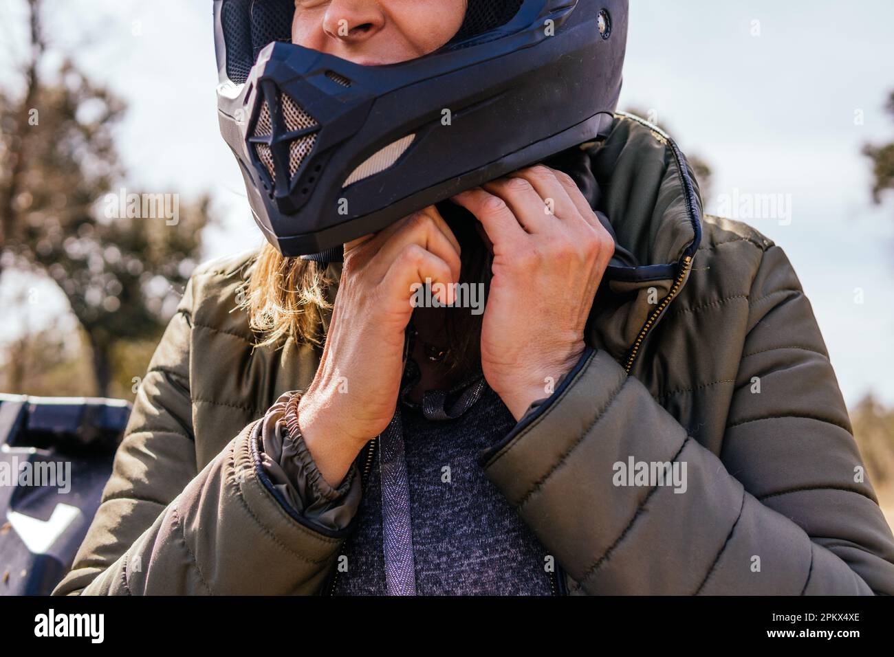 stock photo of woman strapping on motorcycle helmet Stock Photo Alamy