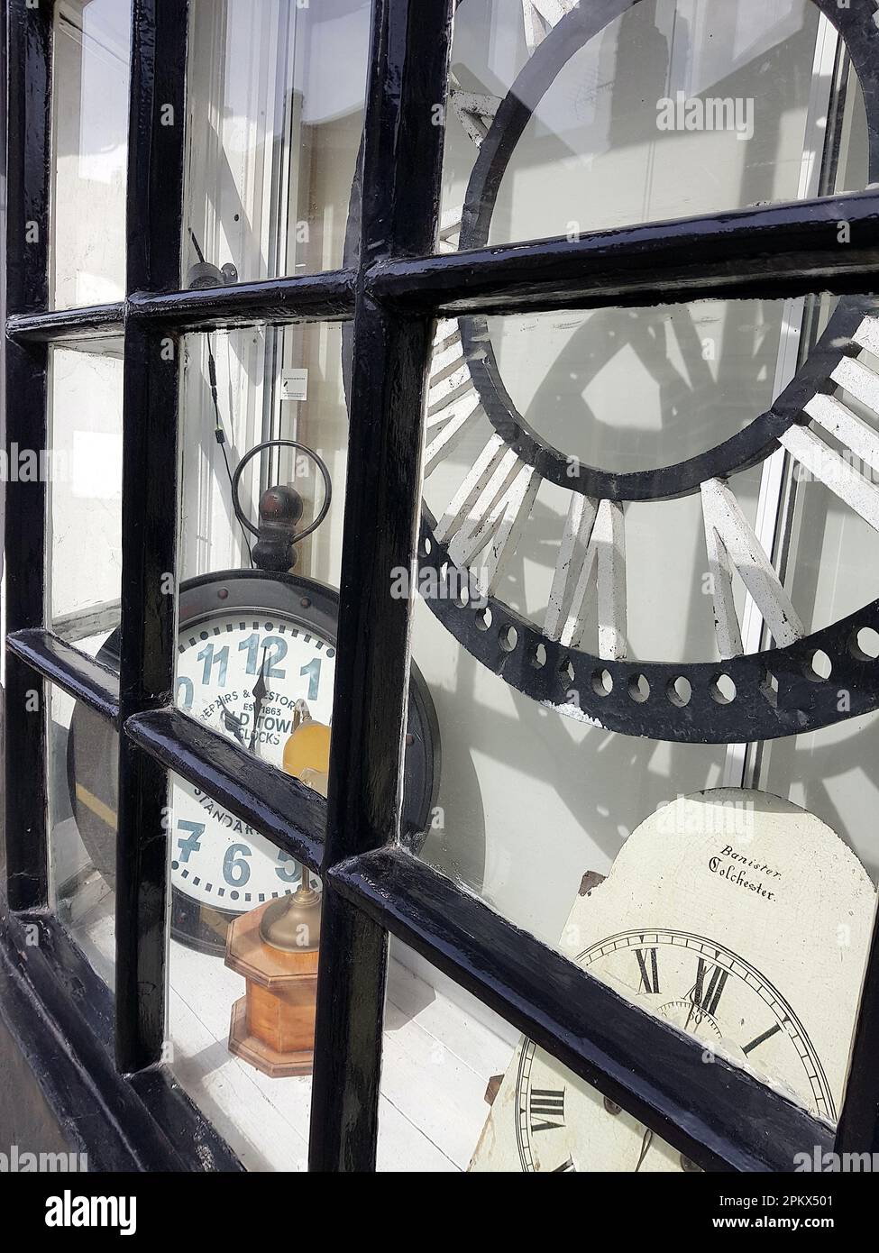 The front window of a shop selling old clocks Stock Photo Alamy