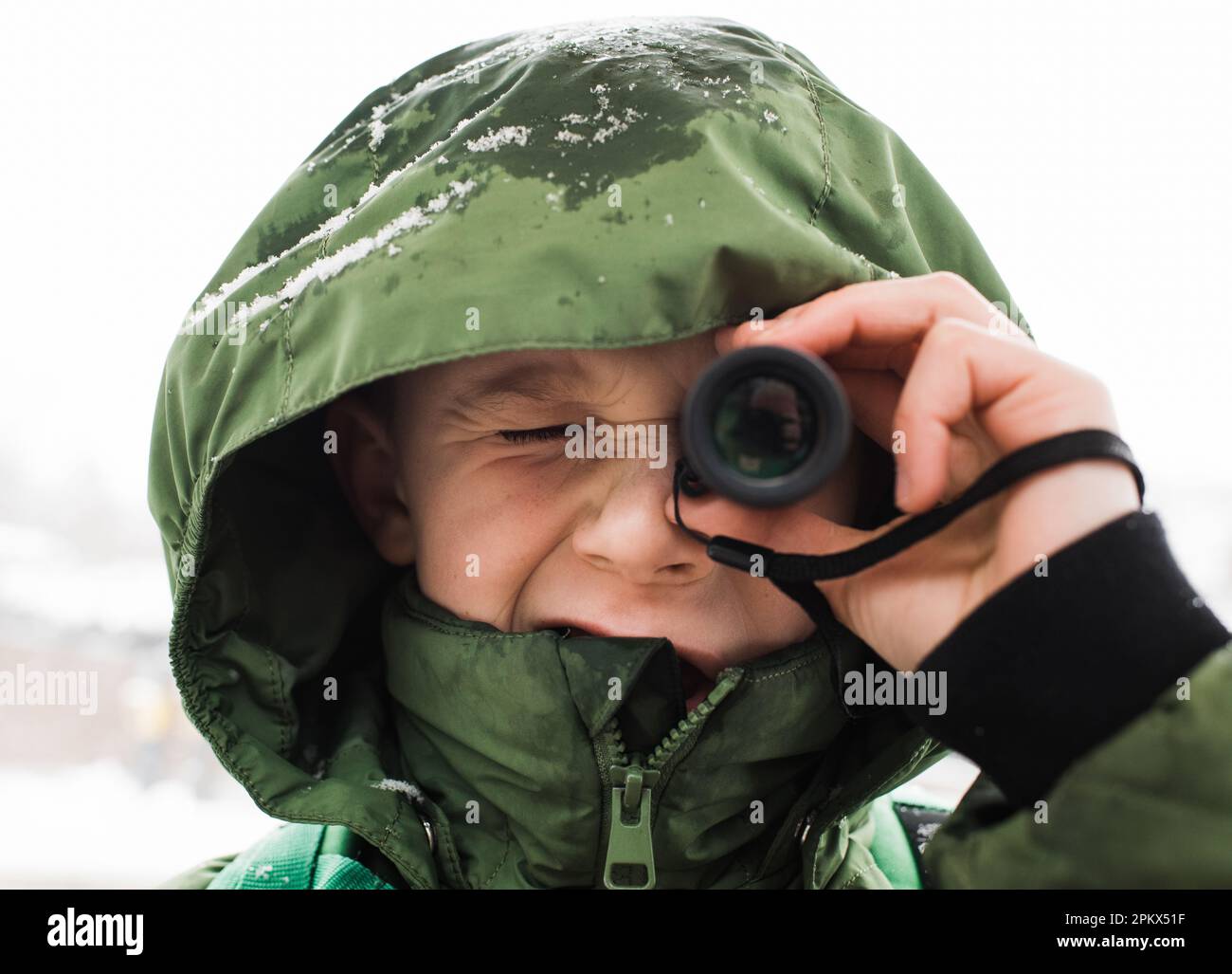close up portrait of boy looking through a telescope Stock Photo - Alamy