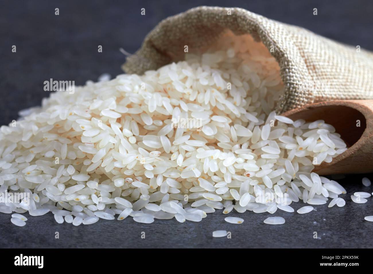 Rice in bag on black stone surfase Stock Photo - Alamy
