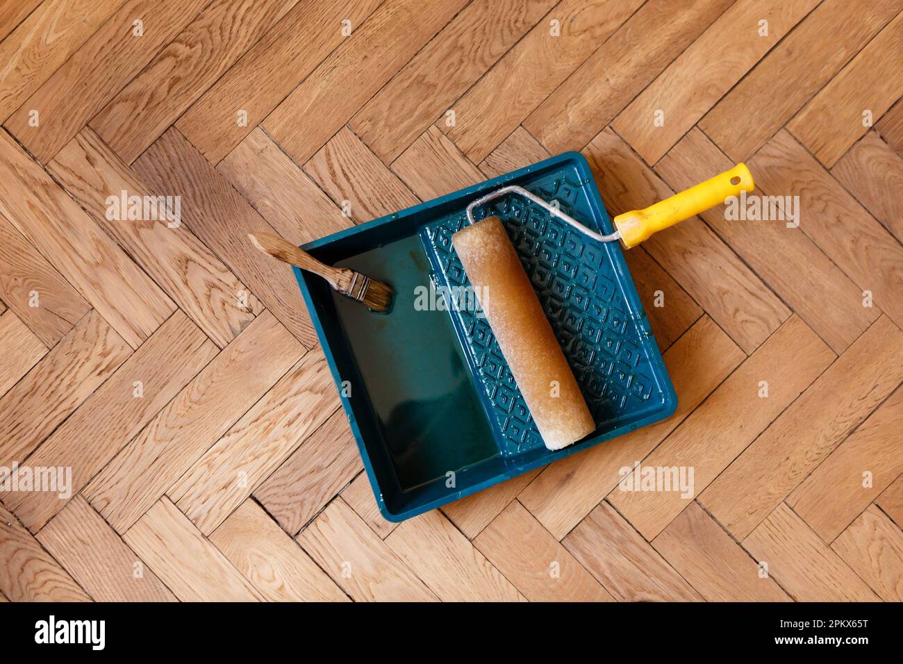 brush and roller in container with varnish during varnishing parquet Stock Photo Alamy