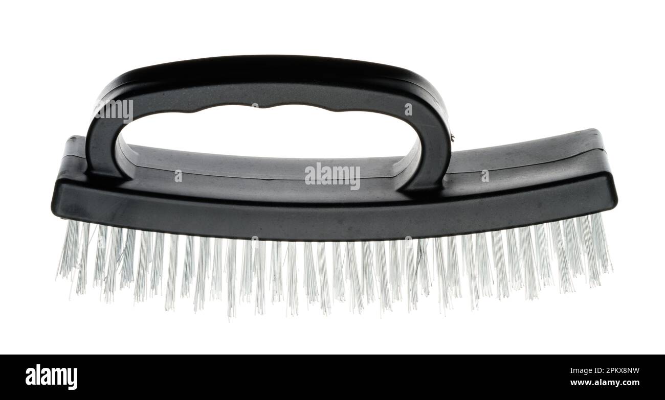 A stiff wire brush for removing old flaking paint from surfaces. Heaving duty scratching device to clean off rust, old flaky paint & surface detritus. Stock Photo