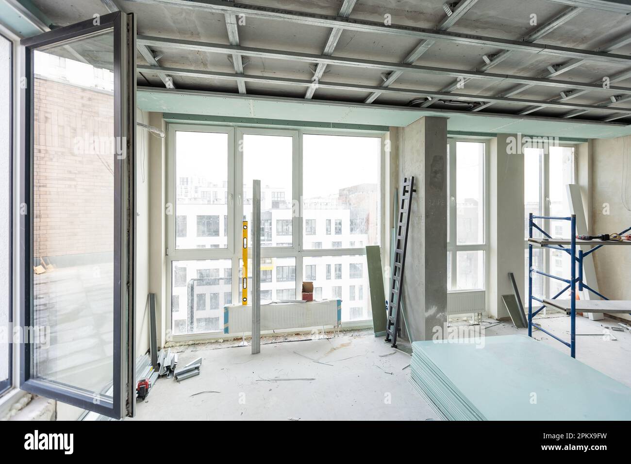 Man assembles profile metal frame for plasterboard ceilings Stock Photo