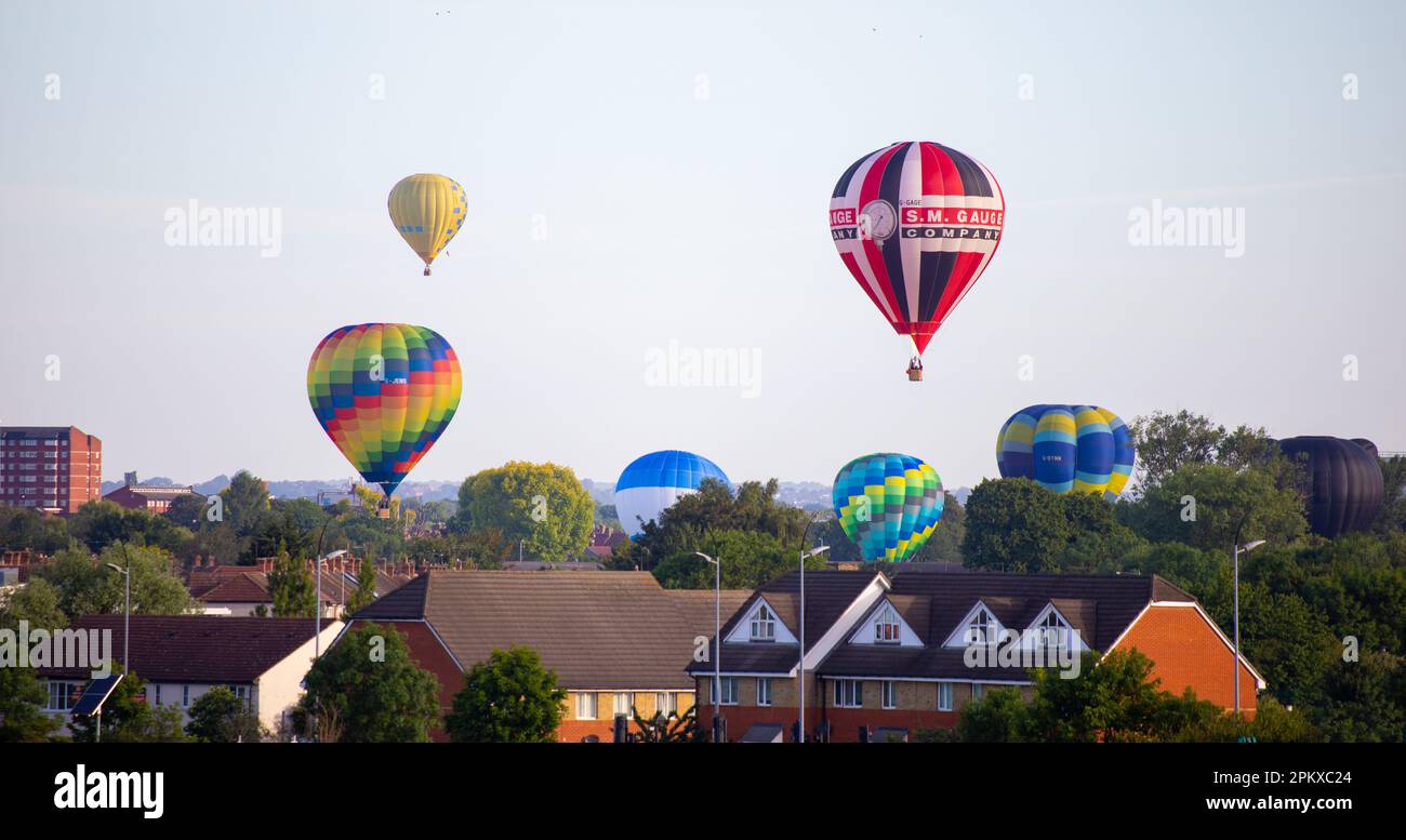 Hot air balloons which are part of the 2019 Lord Mayor's Balloon Regatta land in the suburbs of east London after their dawn flight over the city. Stock Photo