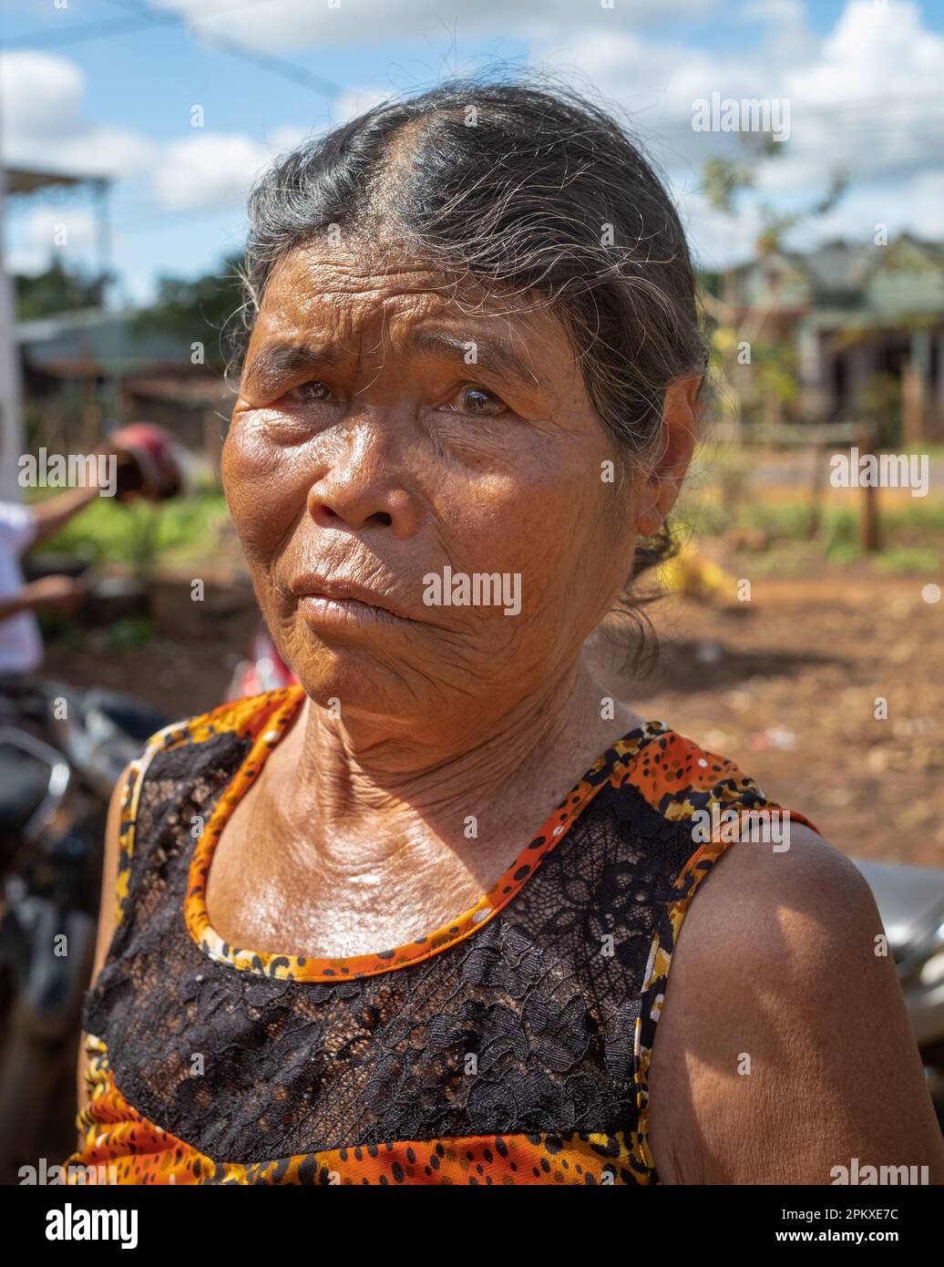 An elderly woman from the Jerai ethnic minority in her village in Gia Lai province in the central highlands of Vietnam. Stock Photo