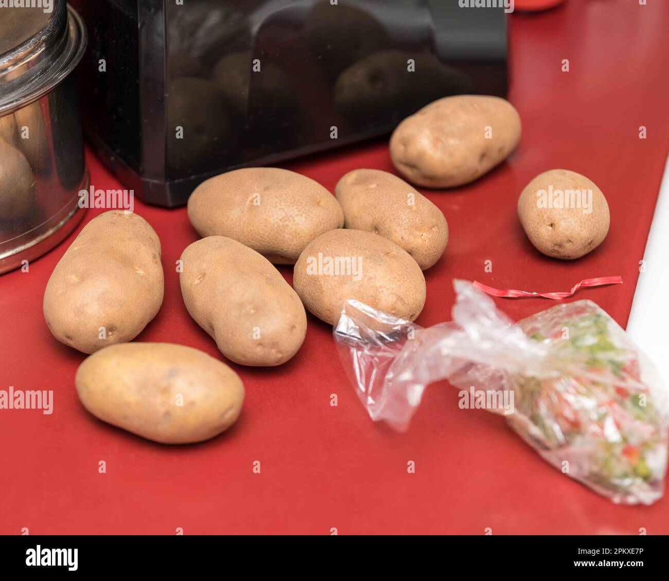 some russet potatoes waiting to be peeled and then mashed for a family