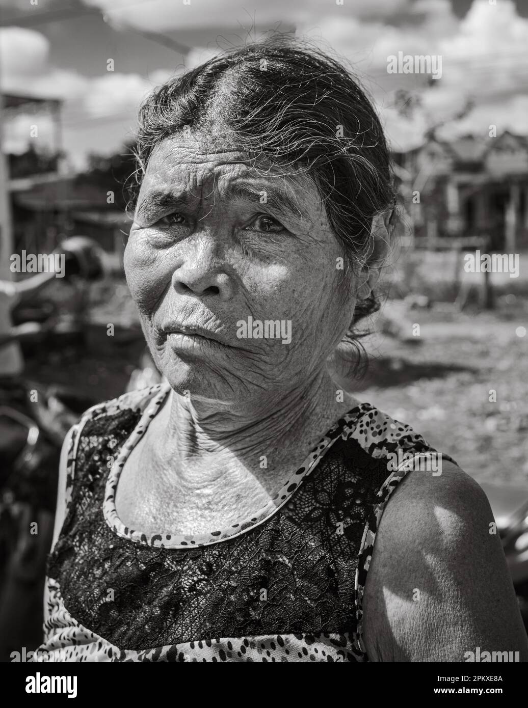 An elderly woman from the Jerai ethnic minority in her village in Gia Lai province in the central highlands of Vietnam. Stock Photo