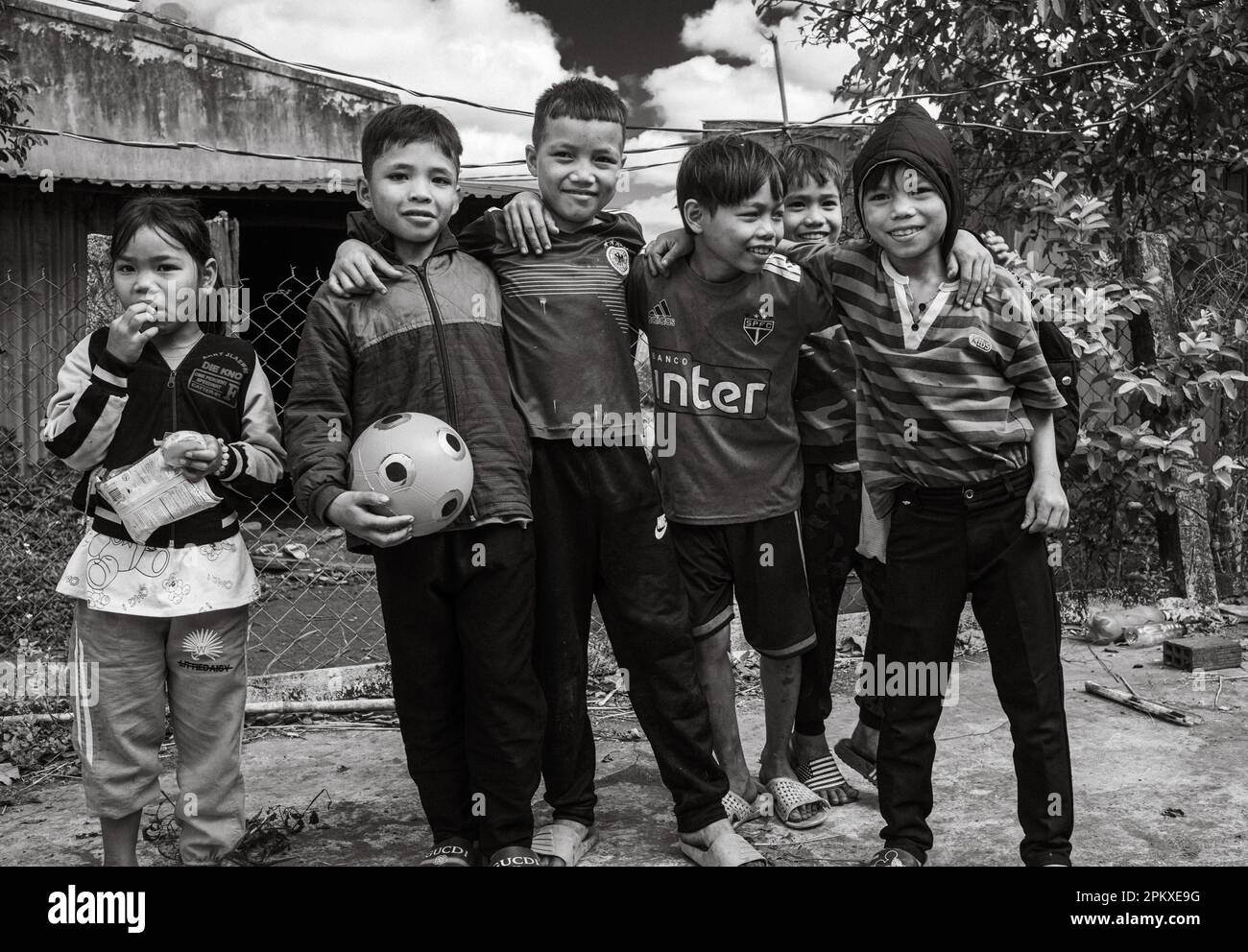 A group of Jerai ethnic minority children with a football in Gia Lai province in the Central Highlands of Vietnam. Stock Photo