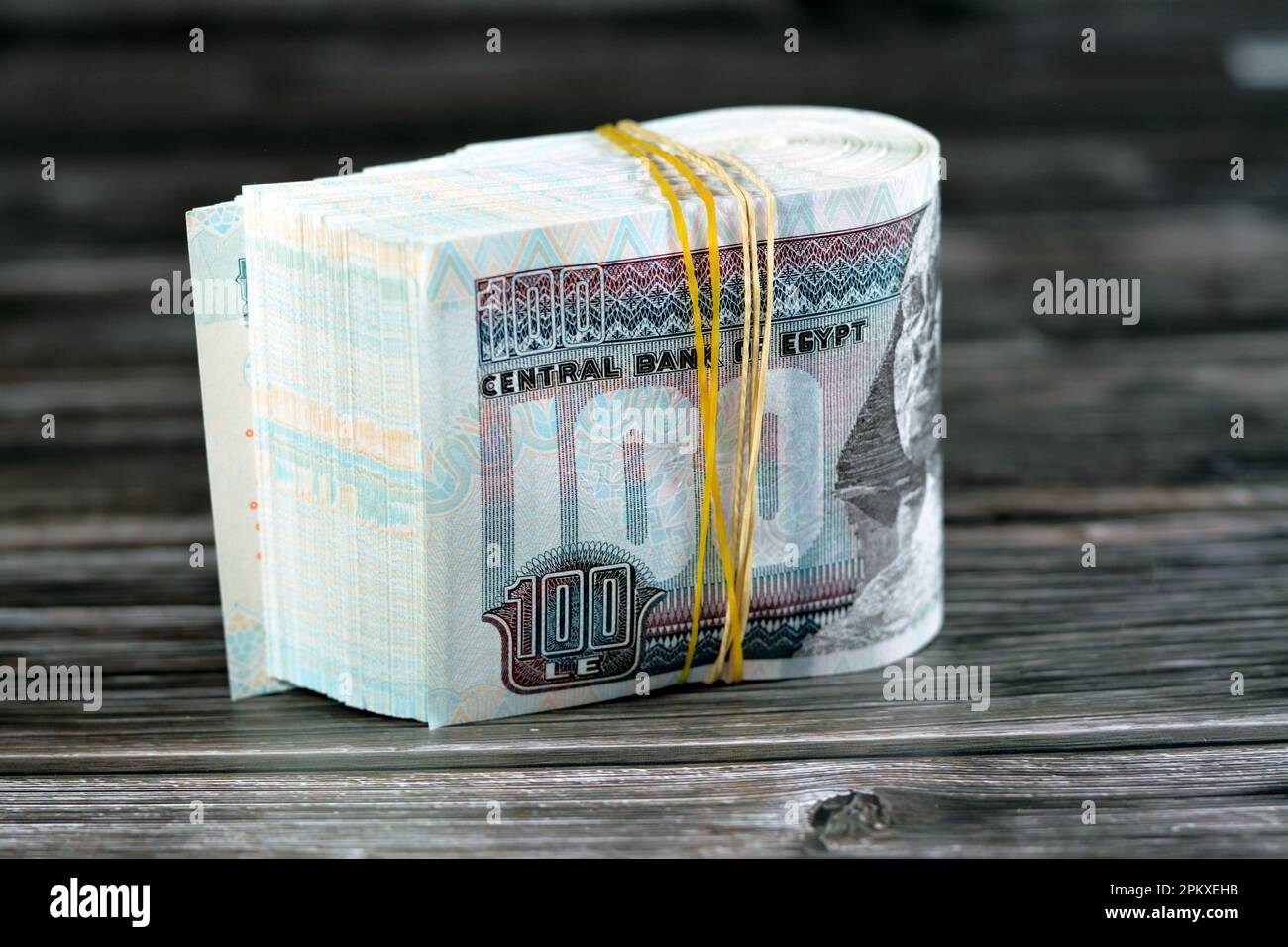 Folded 100 EGP LE one hundred Egyptian pounds cash money bills rolled
