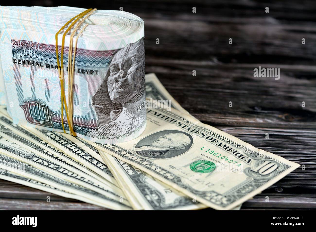 folded-stack-egypt-money-banknote-bills-of-100-and-50-egp-le-one-hundred-egyptian-and-fifty-pounds-on-usa-american-dollars-currency-old-vintage-notes-2PKXET1.jpg