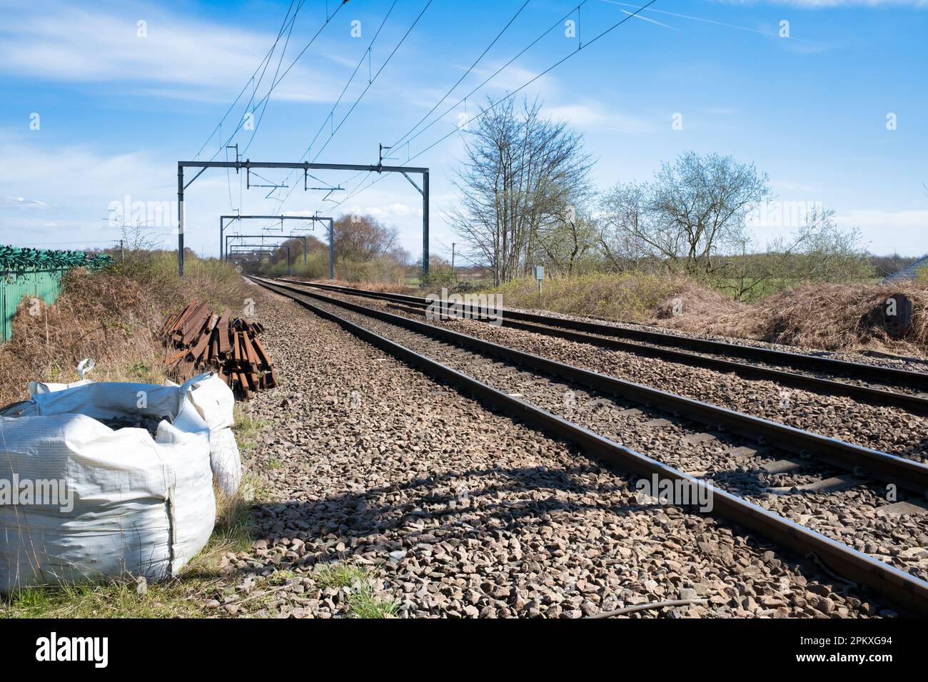 A railway track stretches out into the distance with electrified