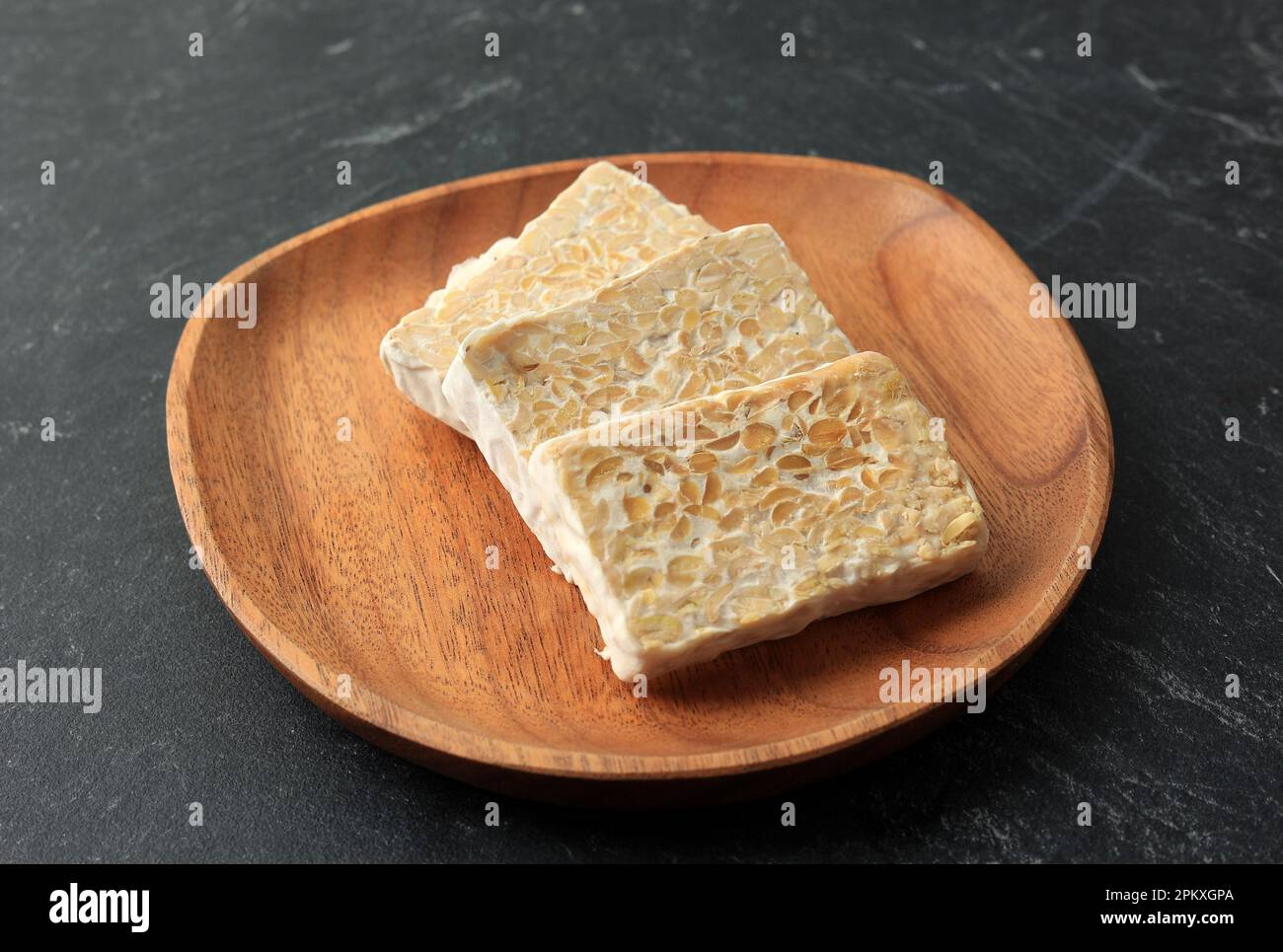 Sliced Raw Tempe or Tempeh on Wooden Plate. Tempeh is Superfoods, Meat