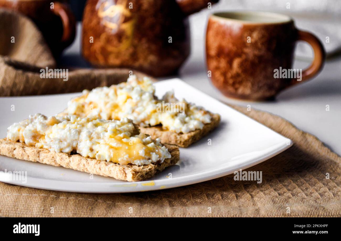 Breakfast of diet bread with cottage cheese and honey Stock Photo