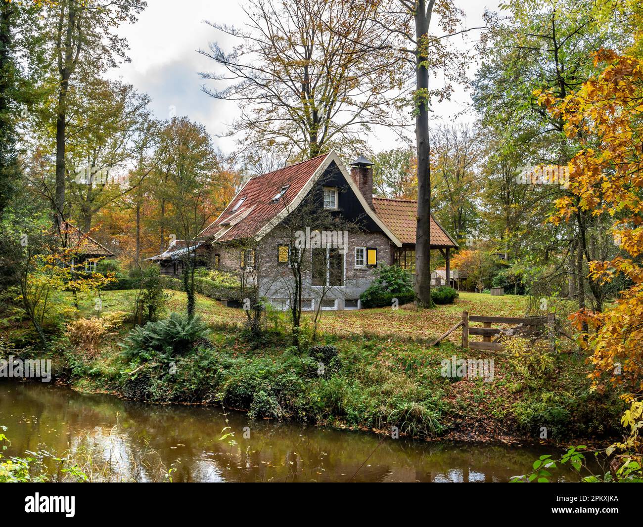 House and Dinkel river in autumn between towns of Losser and Denekamp, Twente, Overijssel province, Netherlands Stock Photo