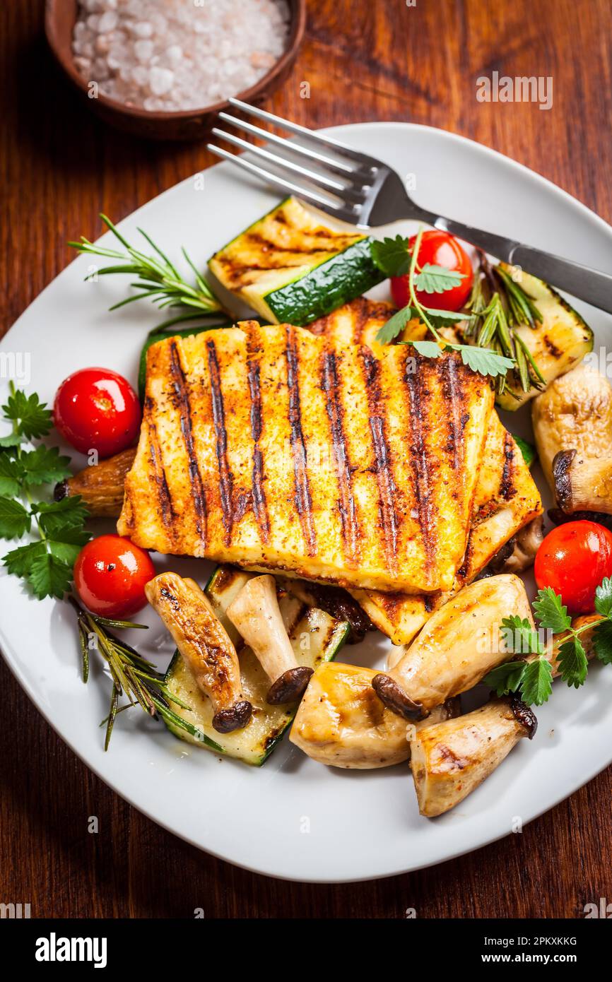 Halloumi grilled cheese on mushrooms and vegetables Stock Photo